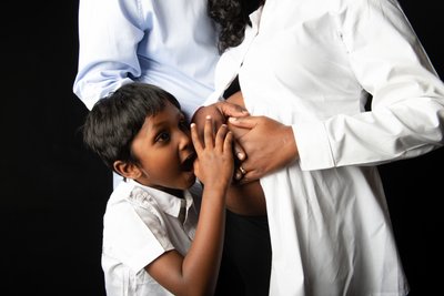 Young Boy Kissing Mother's Pregnant Belly 