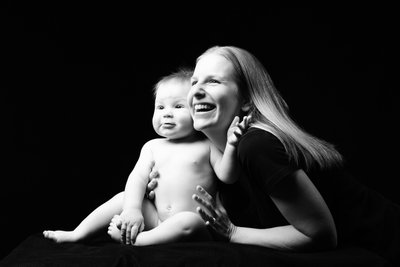 Joyful Mother and Baby Portrait in Black and White