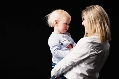 Mum Holding Toddler in Thoughtful Moment