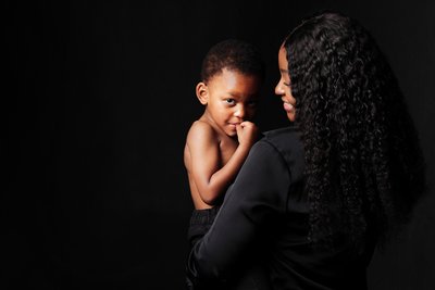 Mum Holding Son with a Quiet, Knowing Look