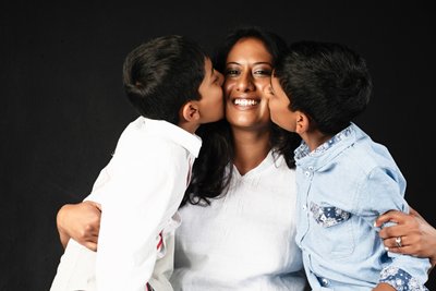 Mum Being Kissed by Her Two Sons