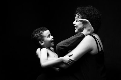 Laughing Mum Holding Her Spirited Son