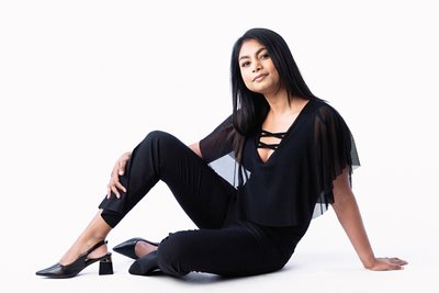 Confident Seated Portrait in Elegant Black Outfit