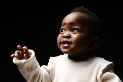 Baby portrait reaching toward the light in Johannesburg