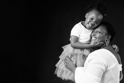 Mother and daughter with child on shoulders