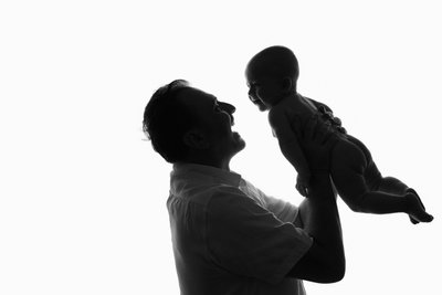 Father Lifting Baby Portrait