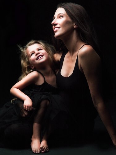 Elegant Mother and Young Daughter in Black Dresses