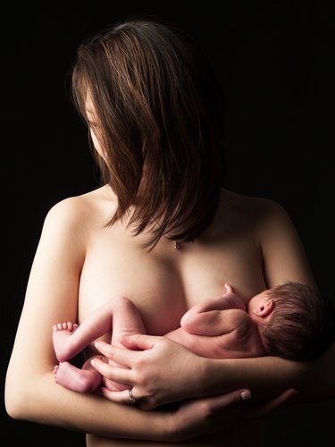 Intimate Maternal Bond: Mother Holding Newborn