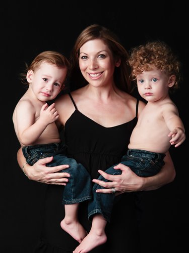 Mum Holding Her Twin Sons in Studio Portrait