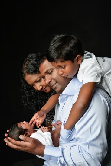 Crying Newborn With His Family