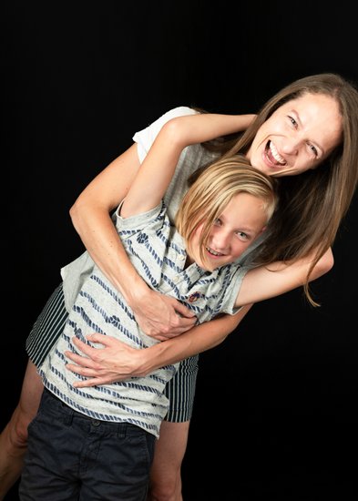 Playful Hug Between Mum and Her Laughing Son