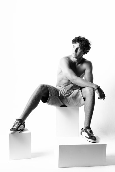 Seated Male Model in Monochrome Studio