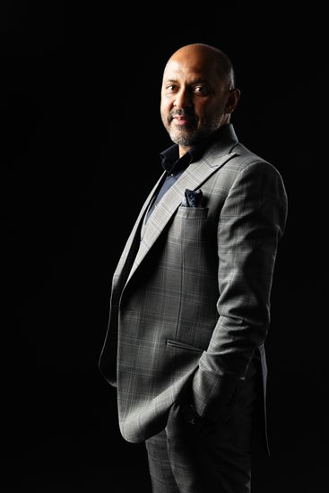 Executive portrait of a man in a grey suit