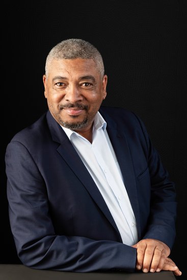 Seated professional headshot of a man