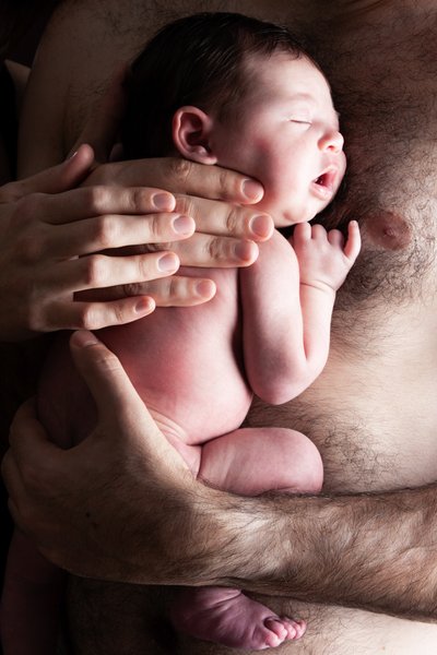 Newborn Sleeping Against Dad's Chest