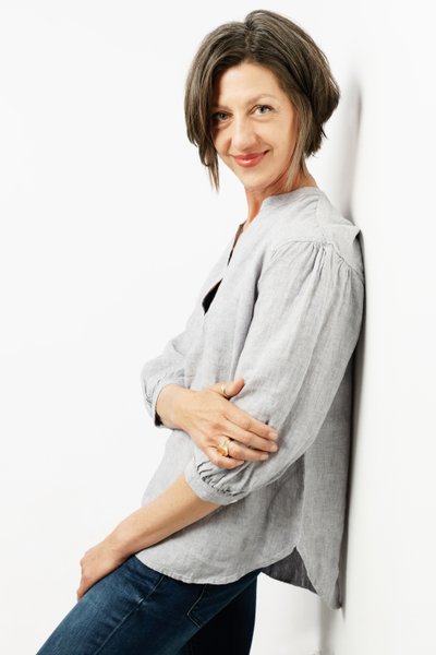 Relaxed Portrait of a Woman Leaning Against a Wall