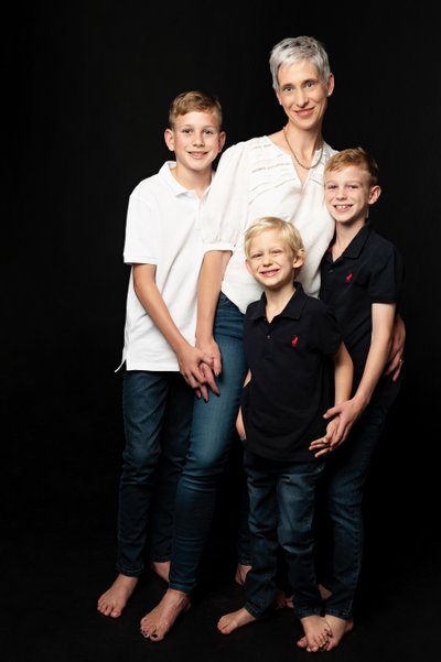 Mum with Her Three Barefoot Sons in Studio Light