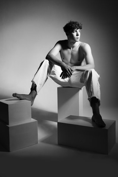 Model in White Jeans Seated on Blocks