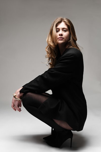 Squatting Fashion Portrait in Black Blazer Dress