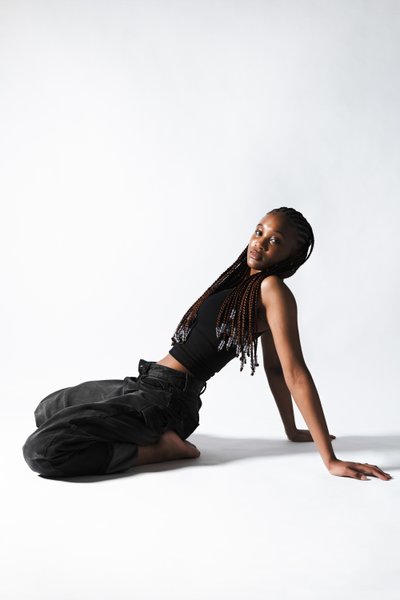 Studio Portrait Reclining in Black Tank Top and Jeans