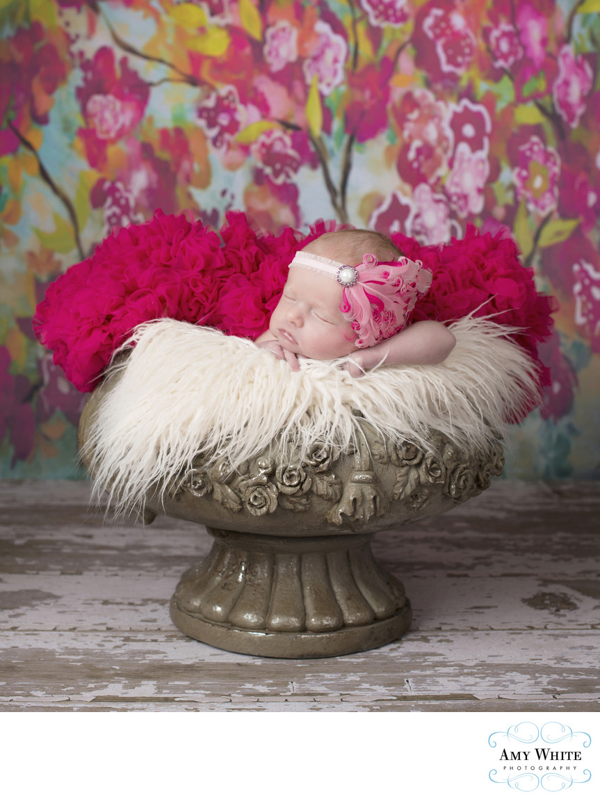 Baby girl in flower pot