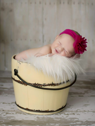 Happy Baby in Bucket Cedar Rapids Newborn Photographer