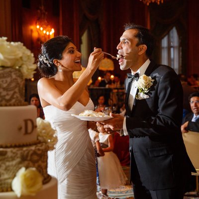 Indian Couple Eats Wedding Cake at Downtown Hotel
