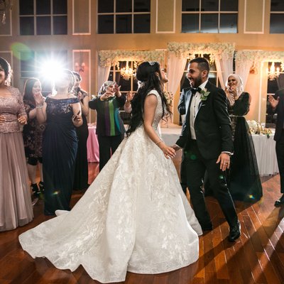 Bride and Groom dance among their guests at reception