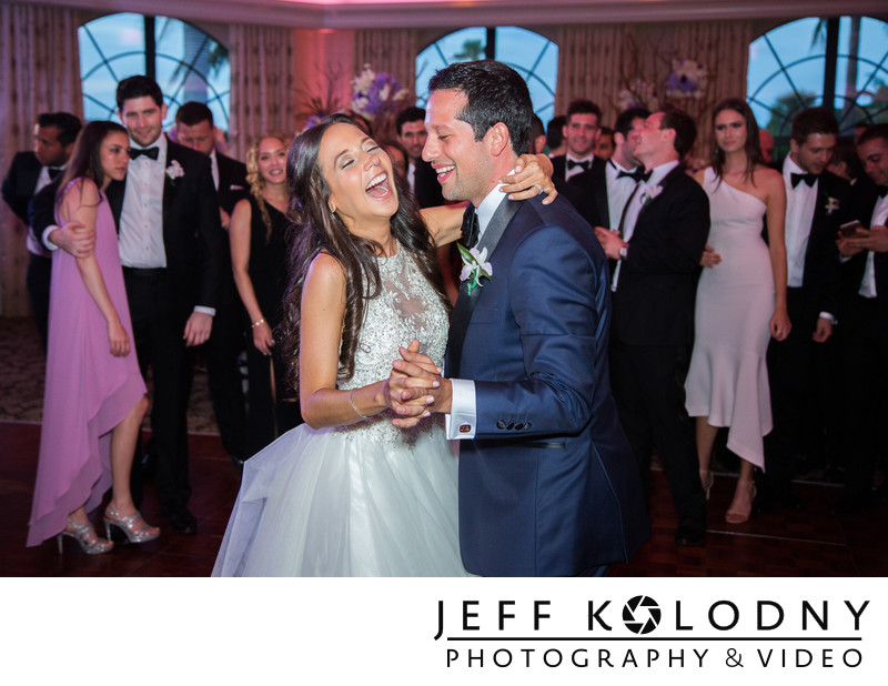 Laughing Bride and groom enjoying their first dance.