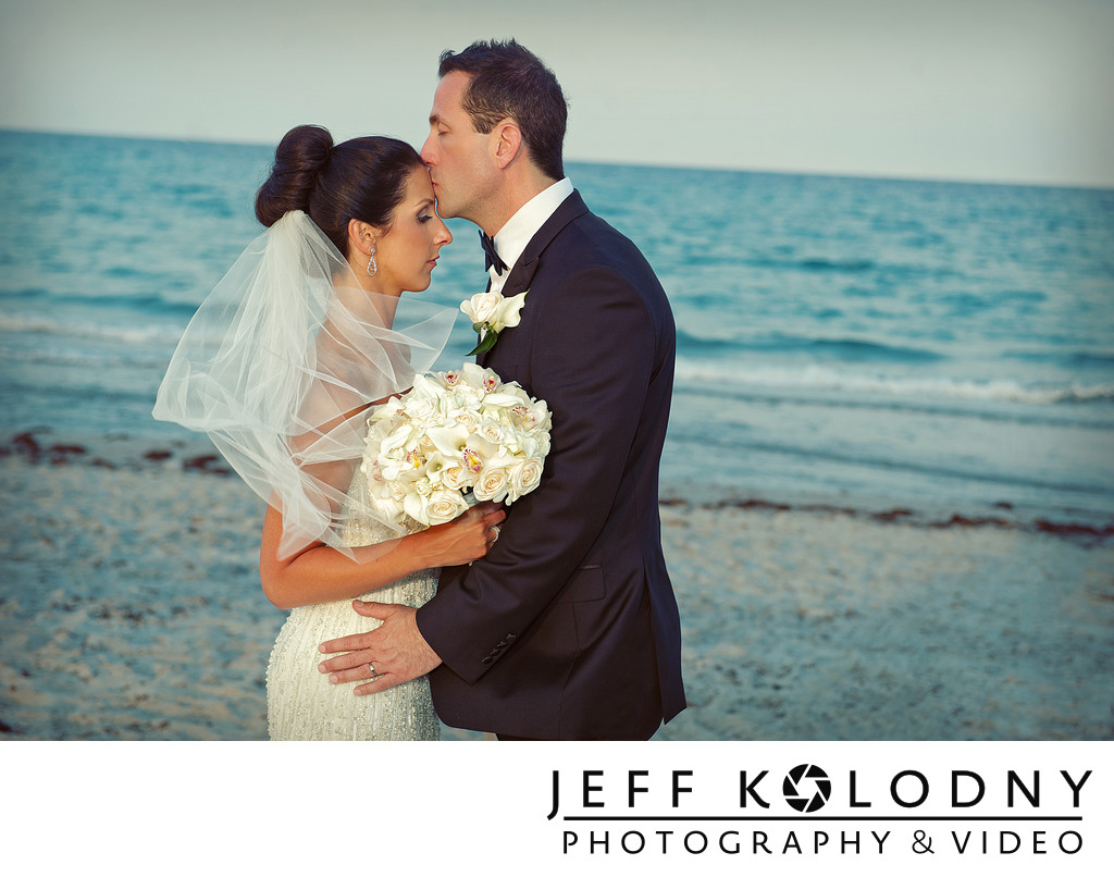 Groom kissing bride at the Delray Beach Marriott