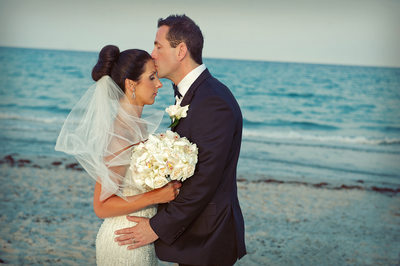 Groom kissing bride at the Delray Beach Marriott