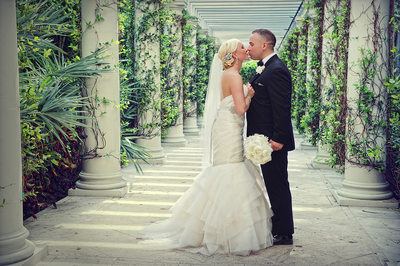 Bride and groom share a kiss at The Breakers