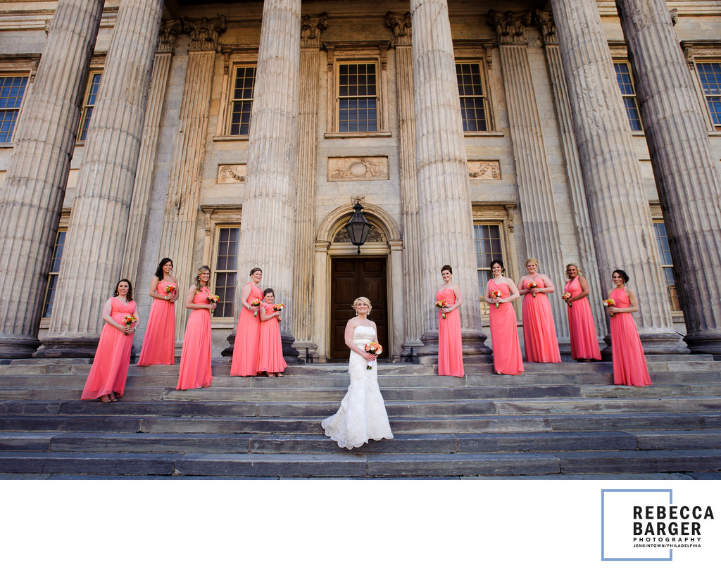 Coral bridesmaids, ionic columns and a lovely bride. 
