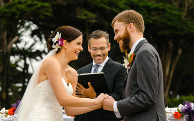 A Wedding Couple laugh during their Wedding Ceremory at SF Zoo