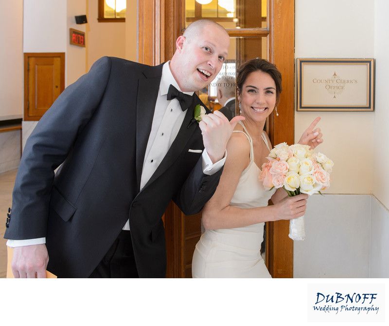 country clerk check-in with bride and groom pointing