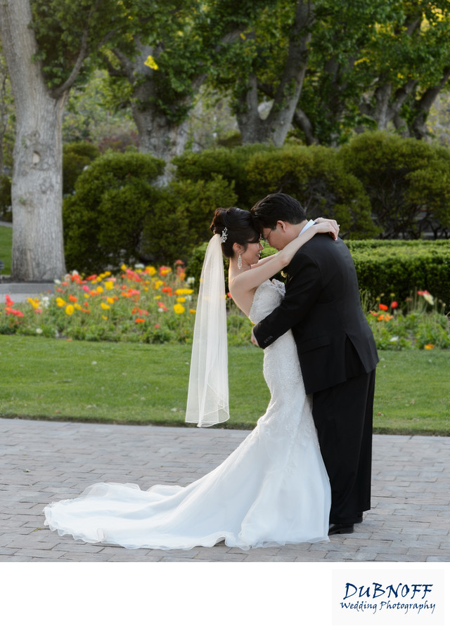 Wente Vineyards Bride and Groom posing in the Flowers