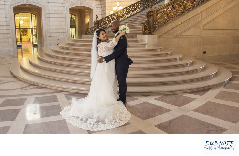 Mixed race couple happy to get married in front of the Grand Staircase