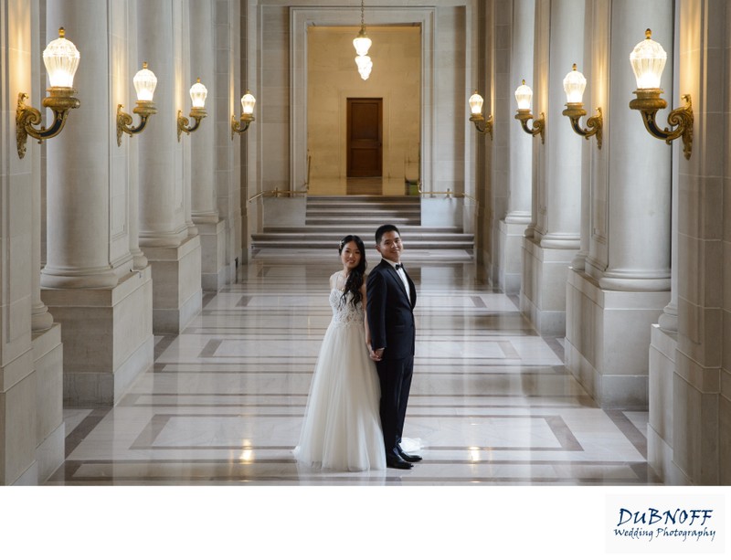 wedding photography at SF City Hall in hallway back to back