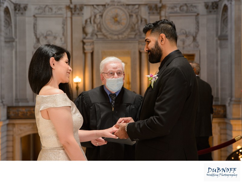 San Francisco city hall wedding photographer - Exchanging rings