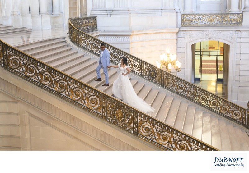 Bride and Groom walking up the Grand Staircase at SF City Hall