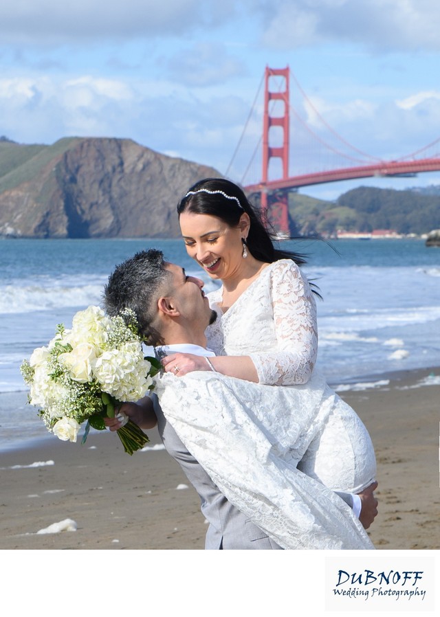 Groom lifting bride at the Golden Gate Bridge - wedding photography