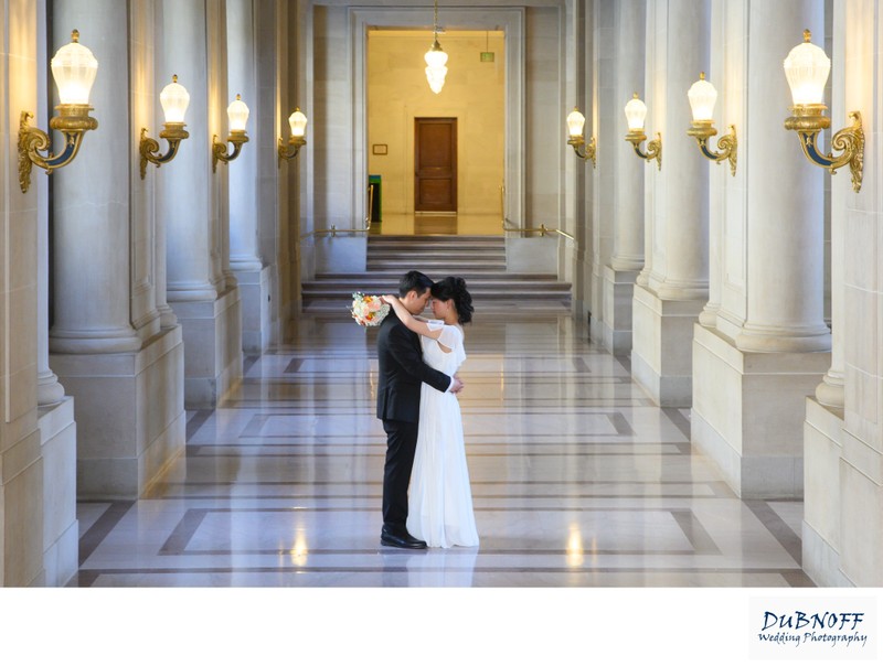Bride and Groom posing at the 2nd Floor Hallway in San Francisco City Hall