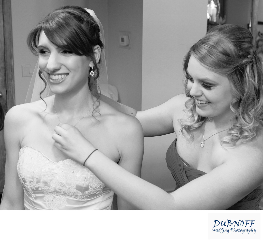 brides necklace being fitted by bridesmaid in Bay Area