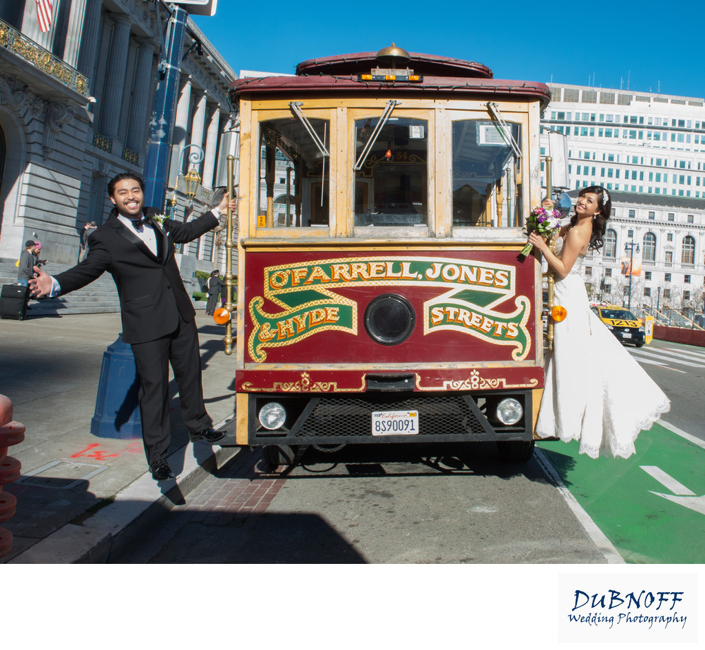 san francisco cable car with Bride and Groom hanging off