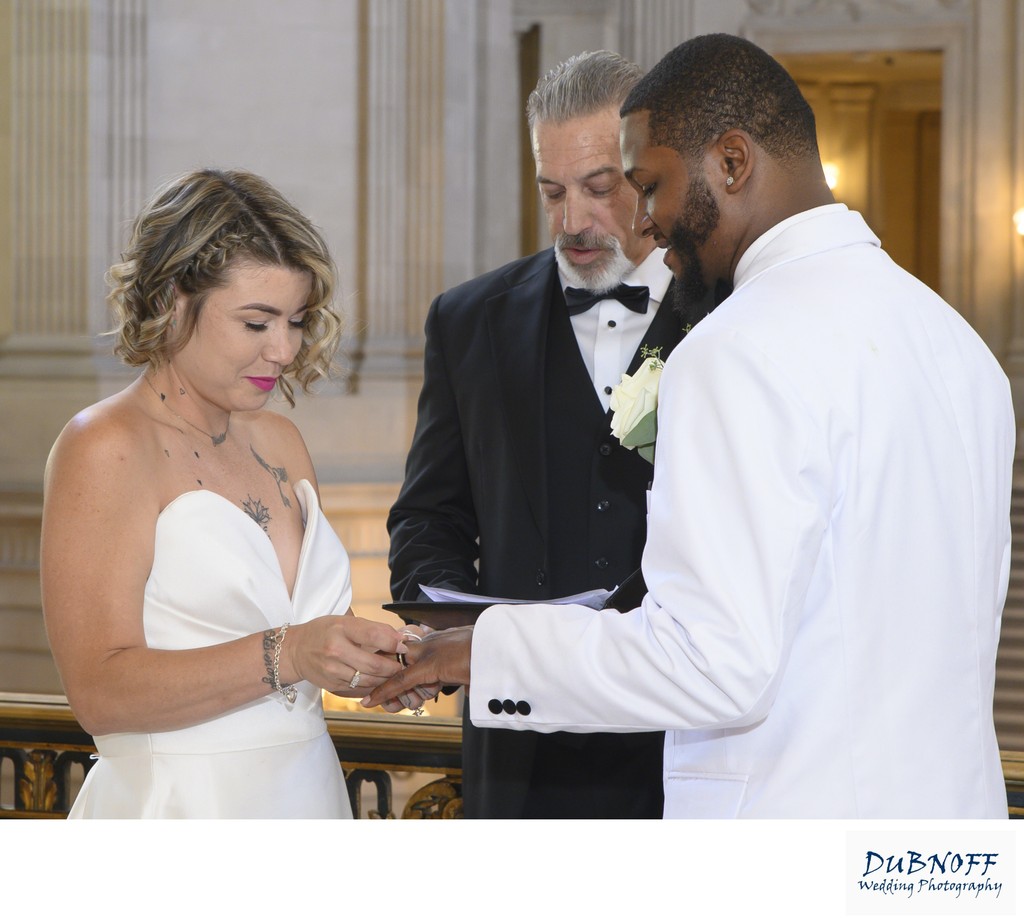 Eloping couple at SF City Hall exchanging rings
