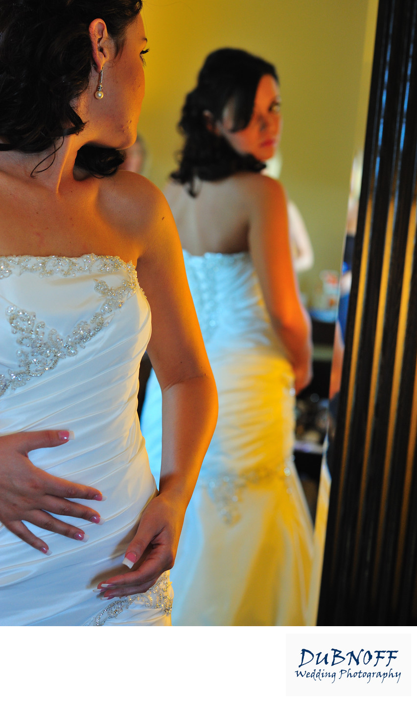 bride looking at back of dress
