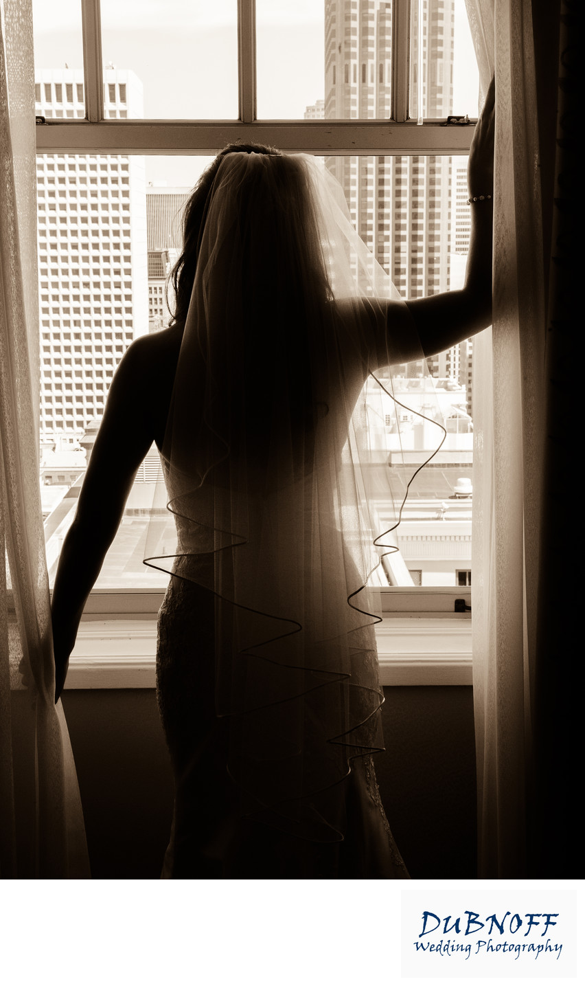 bridal pose in san francisco hotel window in Sepia