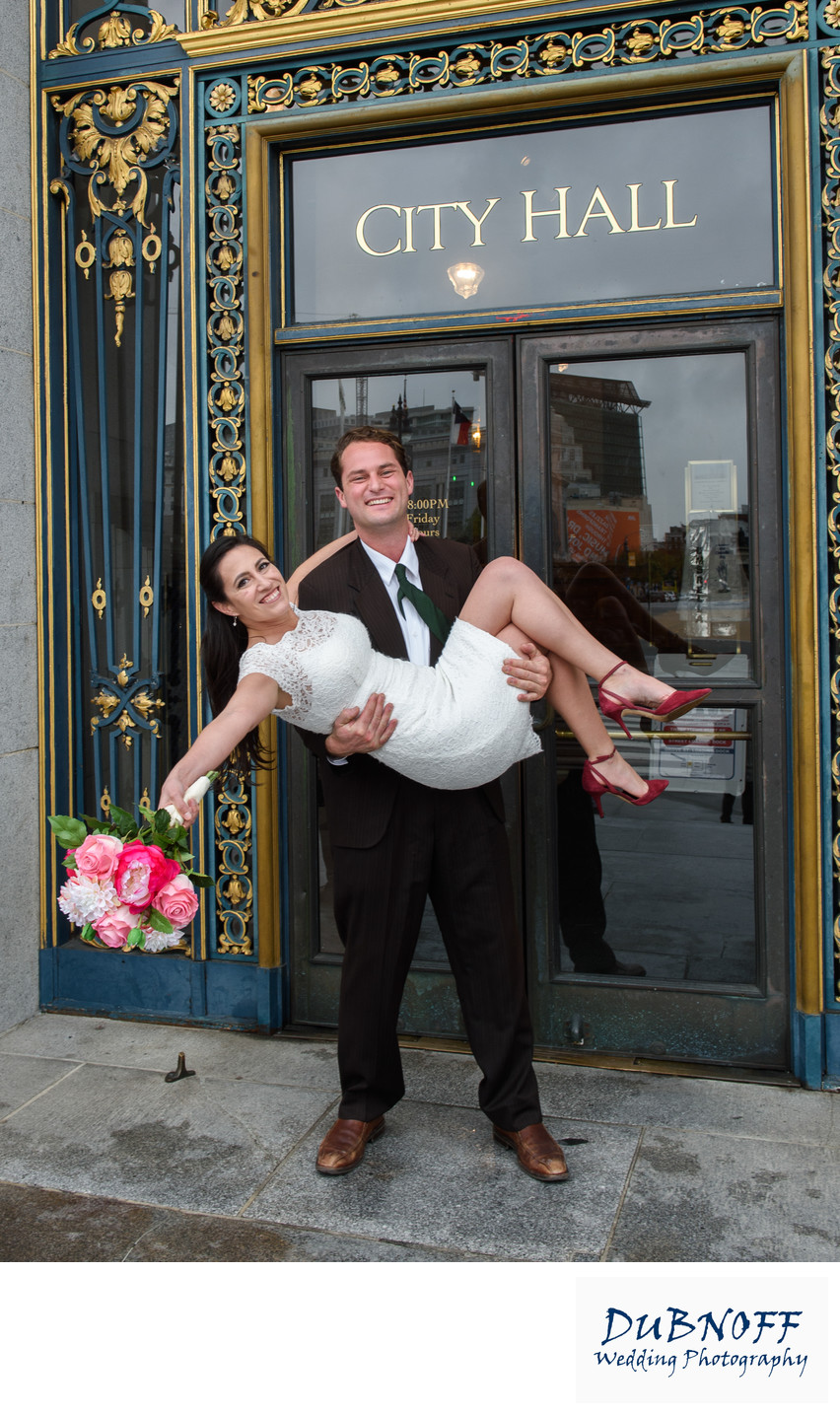 Fun Image of the Bride and Groom at the SF City Hall Entrance