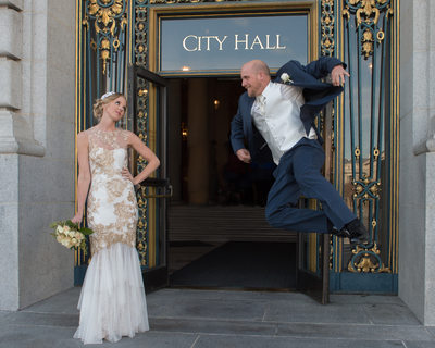 Photo of groom jumping in san francisco at City Hall