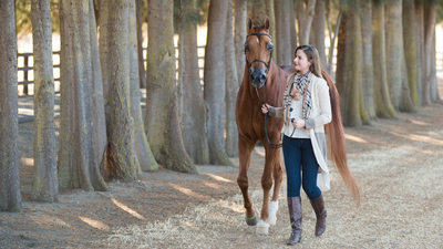 Horse and Owner Enjoying a walk Together by a line of trees